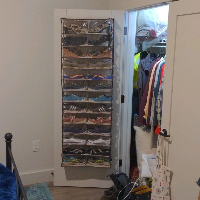A photo from a reviewer showing the shoe organizer mounted on the inside of a closet door.