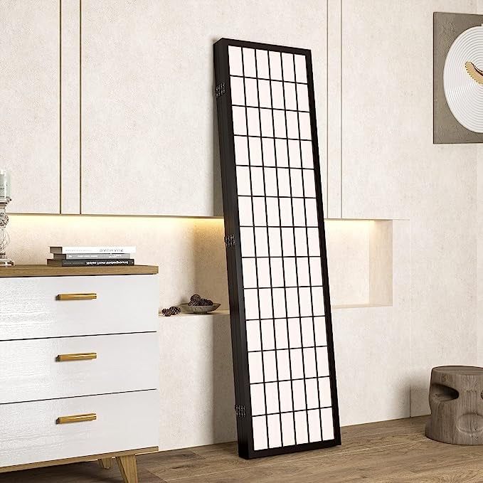 The black divider folded neatly and propped against a wall