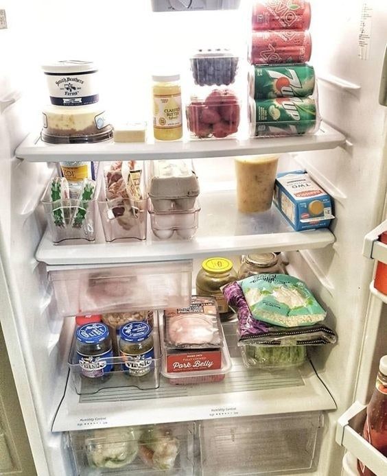 A reviewer's photo showing a beautifully organized fridge with the storage containers in use.