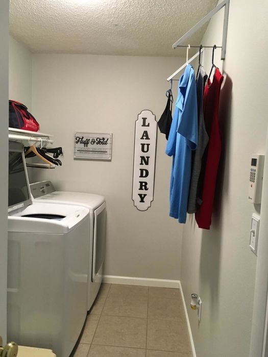 The two retractable racks each holding several garments