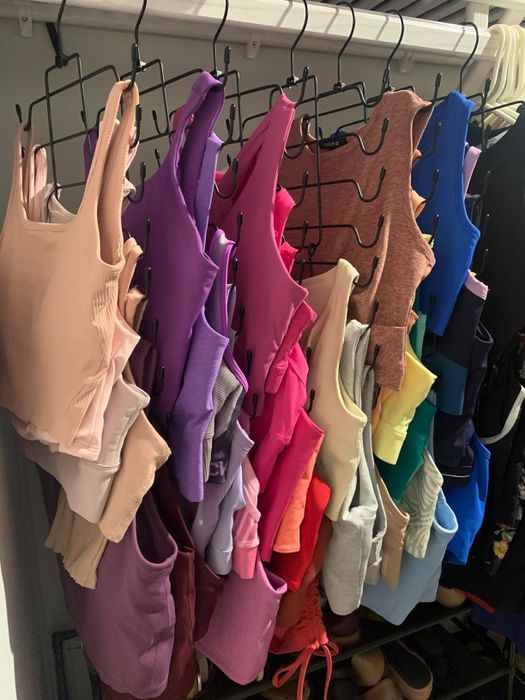 Sports bras organized on the double-pronged hangers