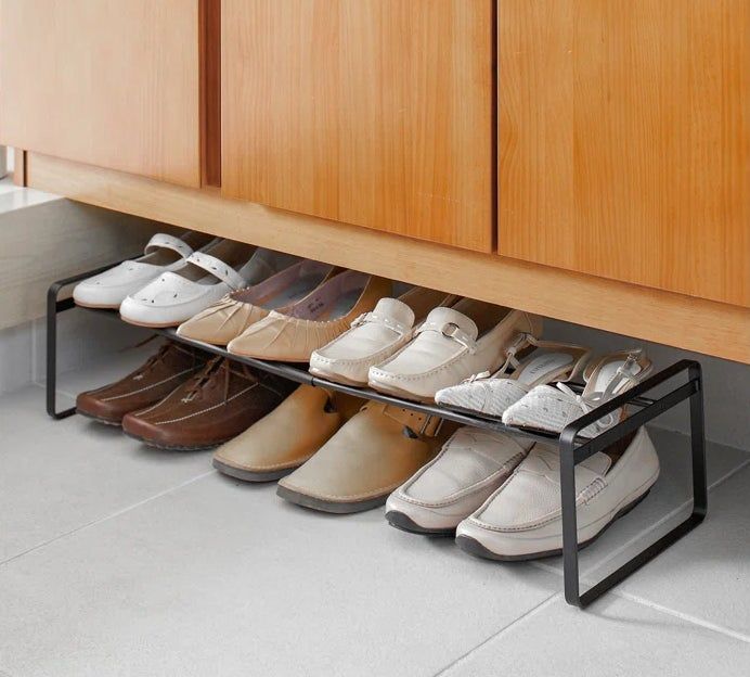 The black rack with shoes neatly arranged on it