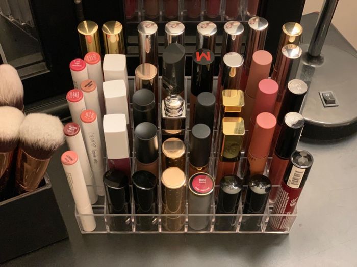 A reviewer’s photo of their lipstick organizer packed with various lip products.