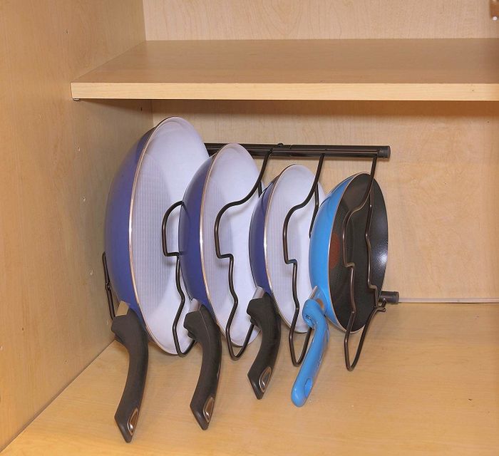 The rack lying on its side, holding the pans in a side-by-side arrangement