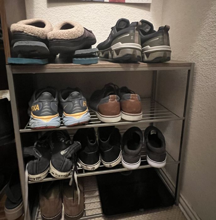 The shoe rack loaded with shoes and a scale