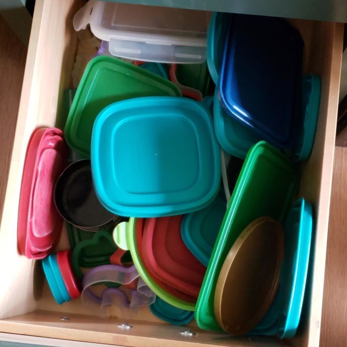 A reviewer's drawer filled with a chaotic mess of mismatched lids