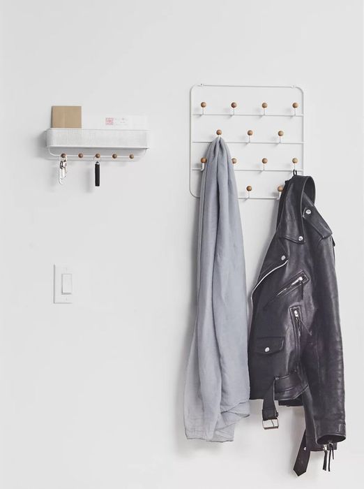 an over-the-door organizer holding a shirt and a leather jacket