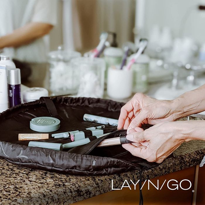 A lifestyle image showing makeup neatly arranged in a Lay-n-Go bag.