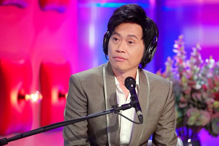 A transparent acrylic makeup organizer neatly holding a variety of beauty essentials, including NYX lip glosses, foundation, brushes, and skincare products.