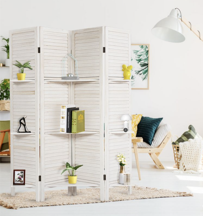 A white room divider with shelves showcasing framed photos, plants, and decorative vases