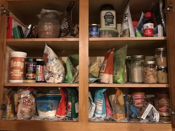 Reviewer shows a photo of a disorganized pantry with food packages scattered around.