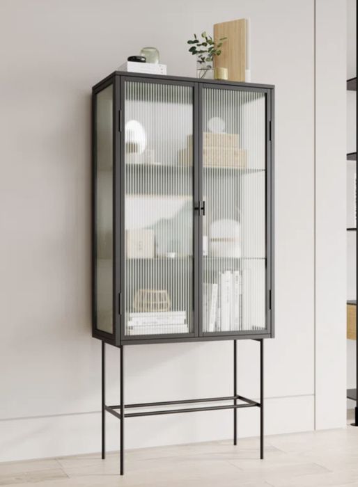 A steel accent cabinet with slightly see-through doors, offering a sleek, modern aesthetic for your space.