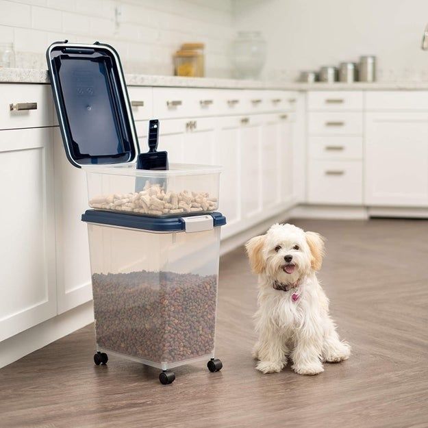 The three-piece set is equipped with wheels and matching dark blue plastic lids, perfect for storing and organizing pet food.
