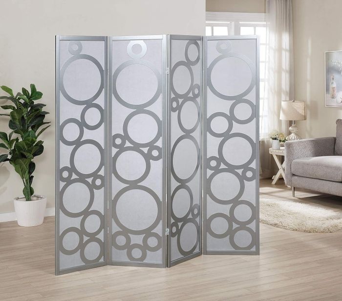 A room divider with circular designs showcased in a contemporary living room setup