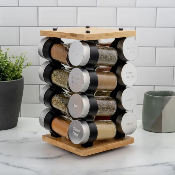 A wooden spice rack placed on a counter.