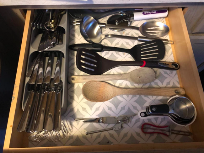 A reviewer's photo showing the silverware organizer on the left side of a drawer, with ample room remaining on the right for additional utensils