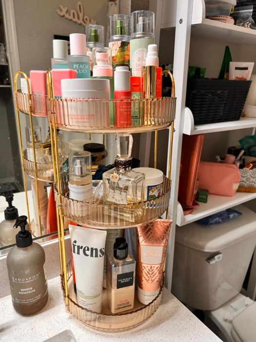 Shelves featuring an assortment of skincare products, including bottles and jars of different sizes, neatly stored on a tiered tray.