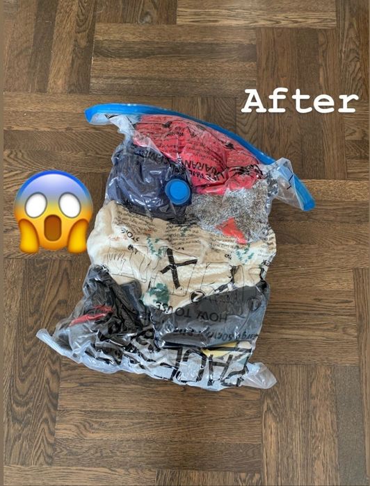The previously large pile of clothes is now neatly compressed into a vacuum-sealed bag, showing a dramatic reduction in size.