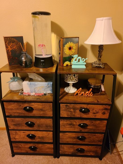 Two wooden dressers with a rustic design and black knobs