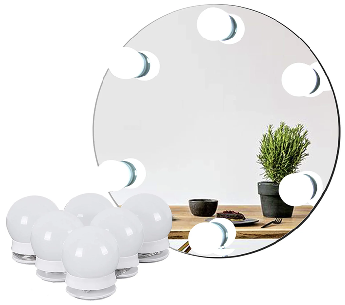 The stick-on lights placed beside a mirror with the lights affixed to its surface