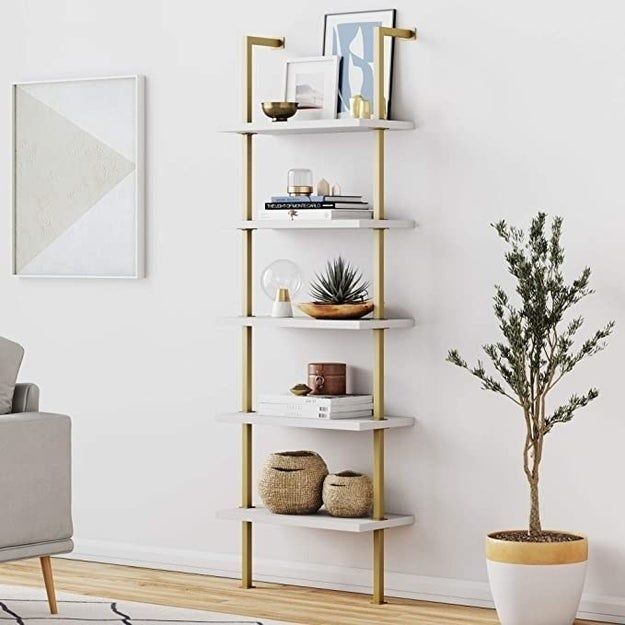 A bookshelf featuring a gold and white design