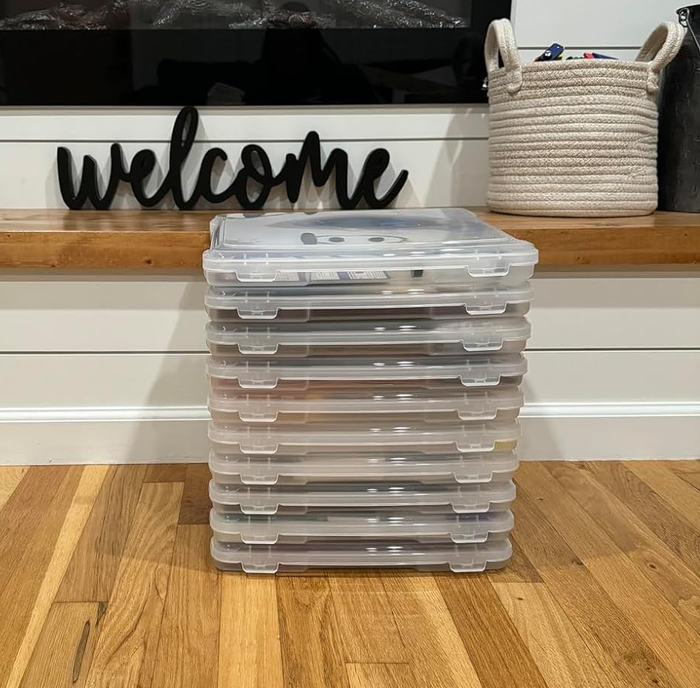 A stack of storage bins arranged in front of a cozy fireplace
