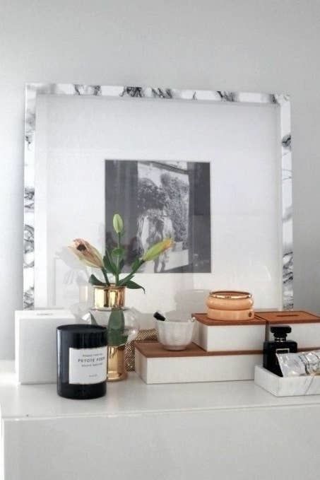 A photo frame wrapped in faux-marble contact paper.