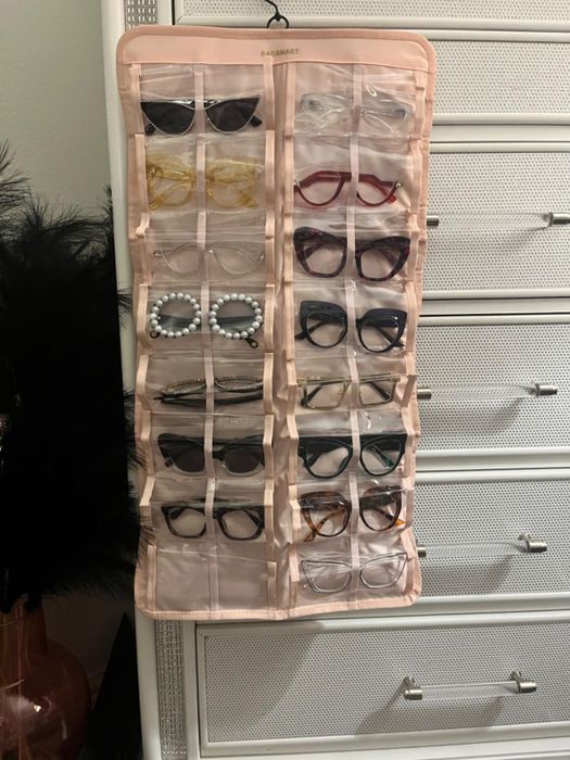 A neatly organized sunglass storage solution featuring various styles like aviators, cat-eye, and round frames