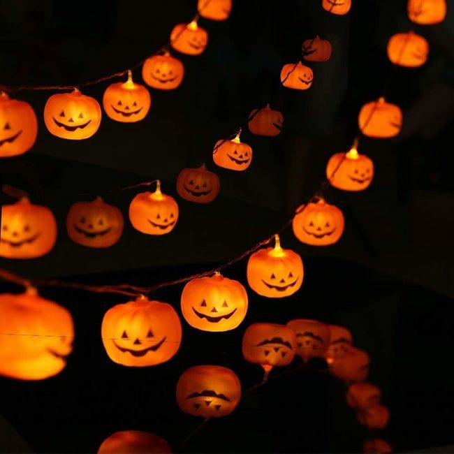 the pumpkin string lights casting their eerie glow in the dark