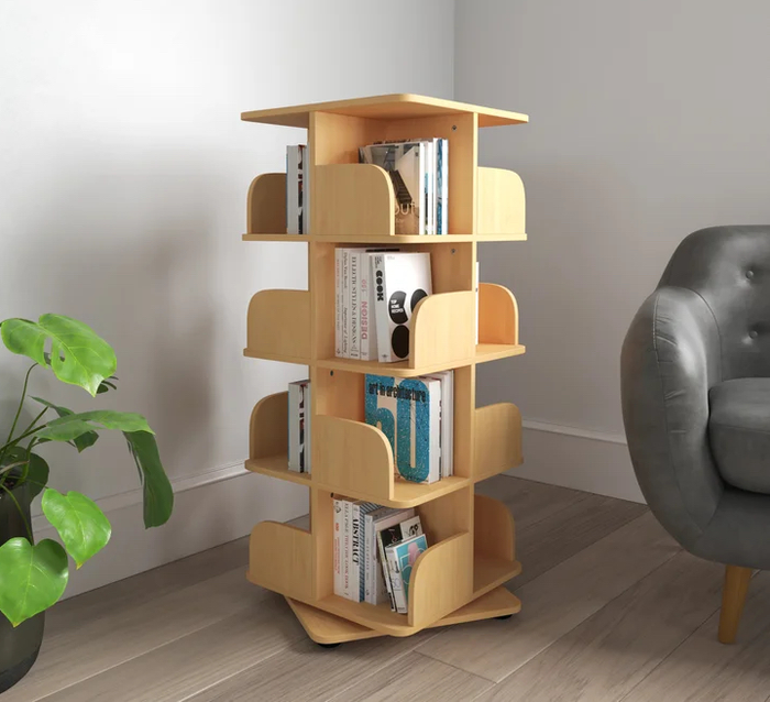 The light-colored, geometric, revolving bookshelf brimming with books.