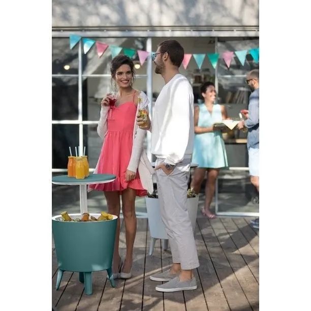 The blue cooler, surrounded by people enjoying their time together and refreshing drinks.