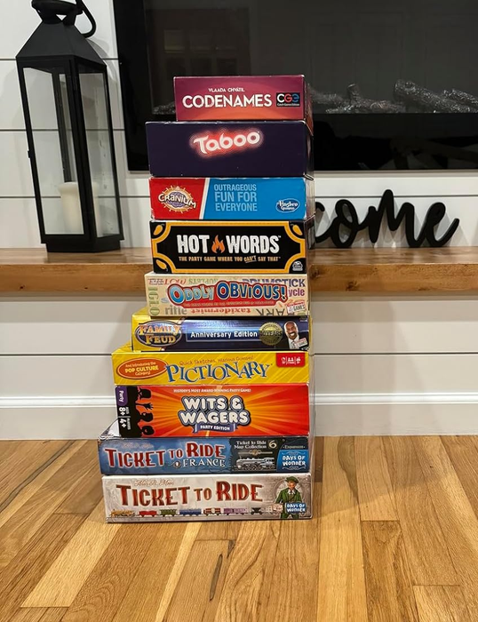 A collection of various family board games, including Codenames, Taboo, Hot Words, Oddly Obvious, Pictionary, Wits & Wagers, and Ticket to Ride