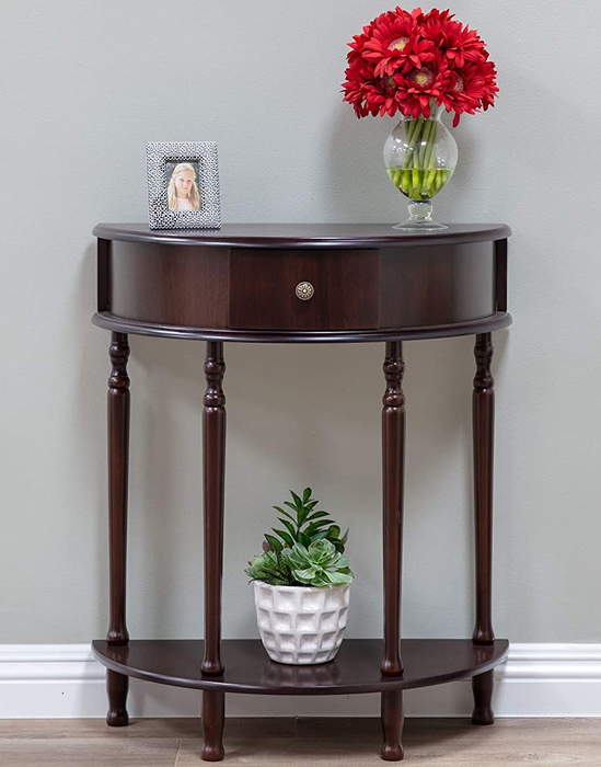The brown table displaying a picture frame and two plants.