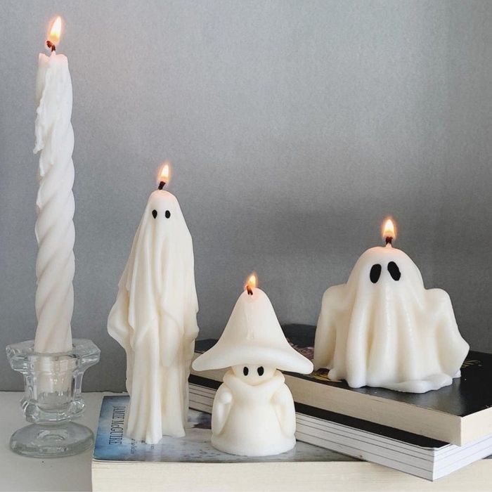 three of the soy wax candles in a variety of ghostly designs