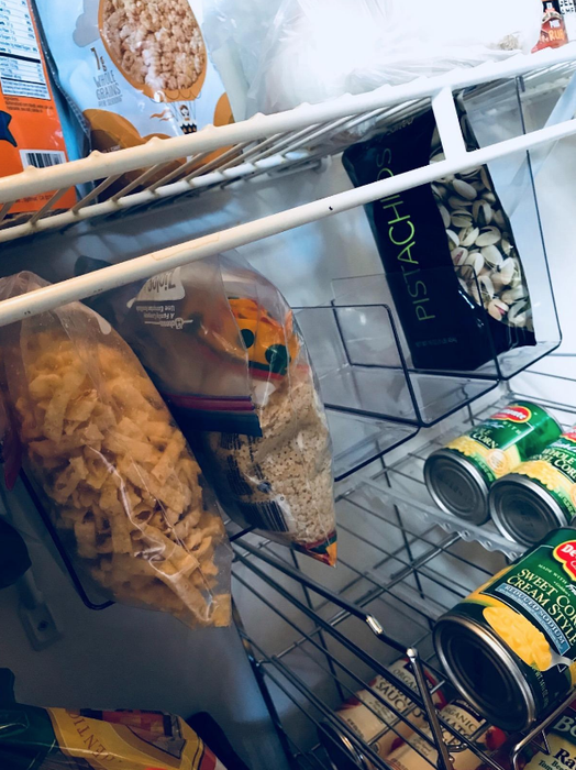Bags of snacks neatly organized in the pantry, placed inside the organizer