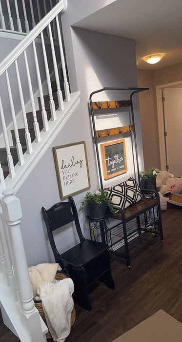 a review photo of the entryway organizer positioned beside a staircase