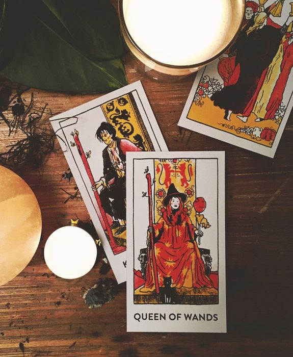 three tarot cards featuring characters from the movie, each in a unique illustrated style