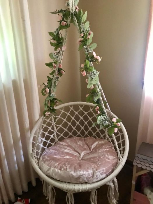 Another reviewer’s swing beautifully decorated with leafy flowers.