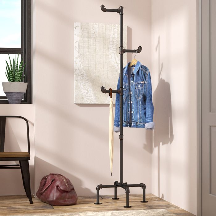 the coat rack positioned near the door, showcasing a jacket and umbrella neatly hung