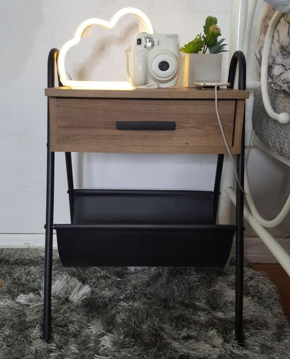 The wooden table with a metal frame, featuring one drawer and a leather hammock beneath it.