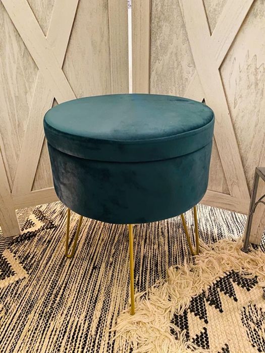 A reviewer’s photo of the teal ottoman/table in its stylish setting.