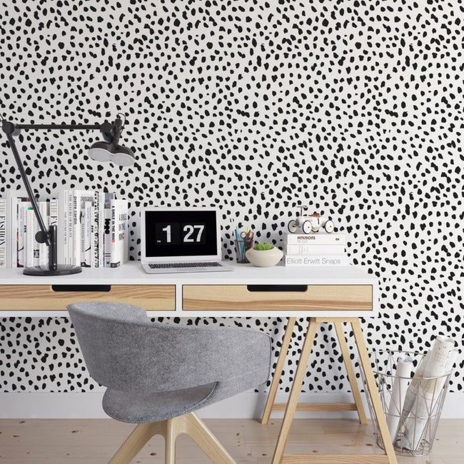 The Dalmatian dot wallpaper installed in a cozy home office space.