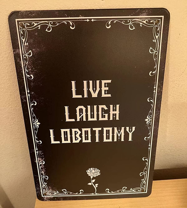 a reviewer's black and white metal sign featuring the phrase