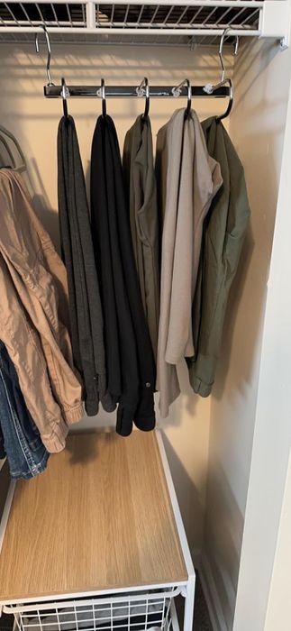 a reviewer's hanger expanded, demonstrating its ability to hold several pairs of pants