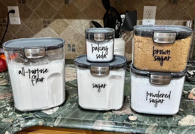 a reviewer's neatly labeled containers on a kitchen counter, storing baking essentials like flour and sugar