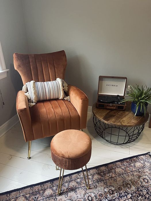 a reviewer displaying the ottoman closed, placed next to a matching chair