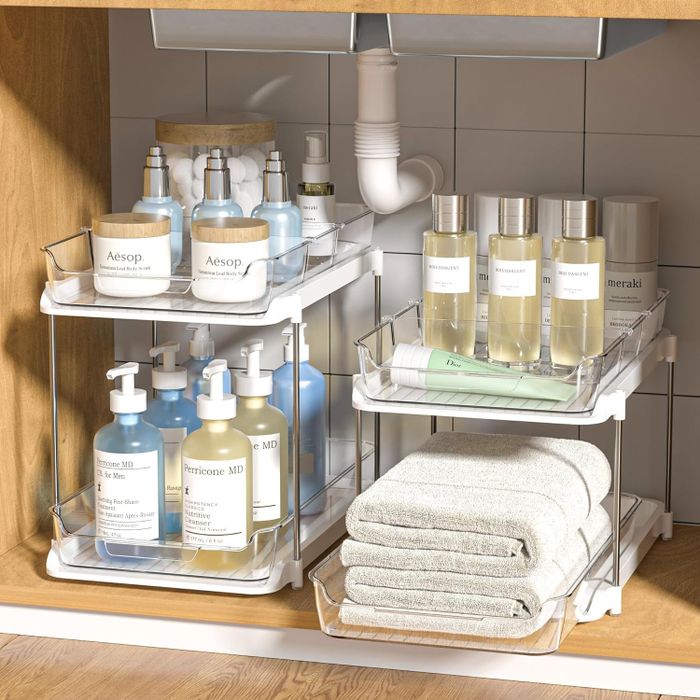 Under-sink storage shelves neatly holding various bathroom essentials.