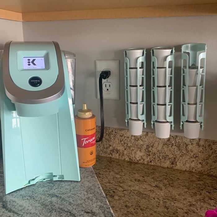 A reviewer's blue coffee pod dispensers mounted beside their coffee machine