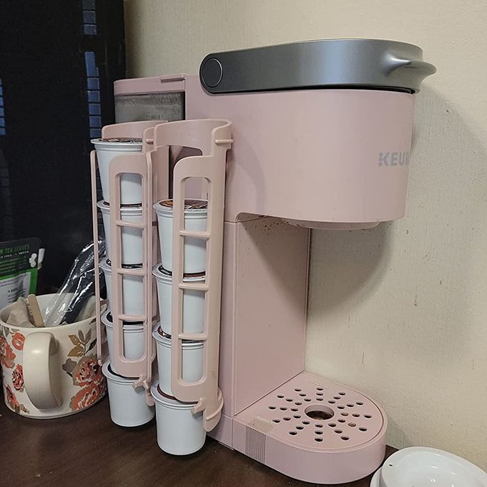a reviewer's pink coffee maker with matching pink dispensers attached to its side