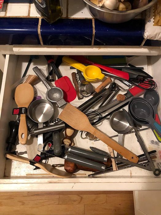 a reviewer's drawer filled with utensils scattered everywhere